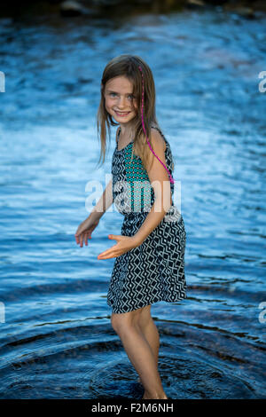 Portrait of a girl standing in water Stock Photo - Alamy