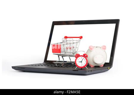 Shopping cart, clock and piggy bank on laptop Stock Photo