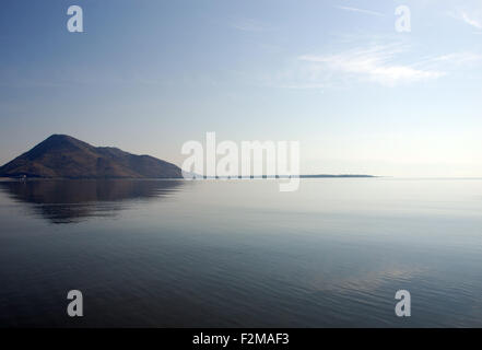 a mountain at the side of  lake Skadar is reflected in the waters of the largest lake in the Balkans Stock Photo