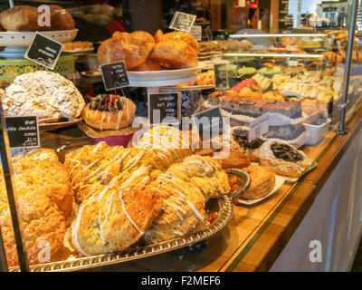 fresh baked pastries displayed in the interior of a bakery and coffee shop Stock Photo