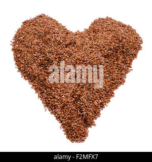 a pile of brown flax seeds forming a heart on a white background Stock Photo