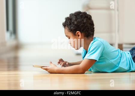 African american little boy using a tactile tablet Stock Photo