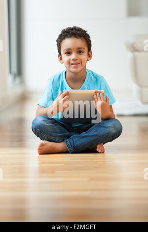 African american little boy using a tactile tablet Stock Photo