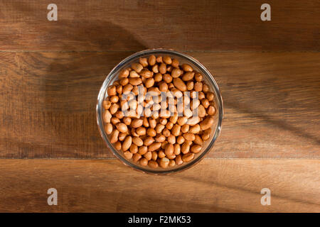 peanuts in a bowl on wood background Stock Photo