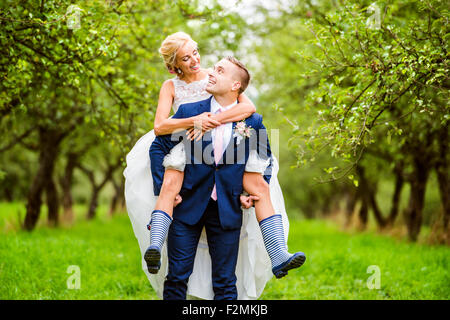 Beautiful young wedding couple outside in nature Stock Photo