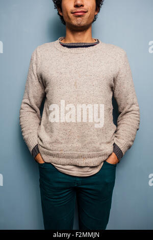 Young man standing with his hands in pockets Stock Photo