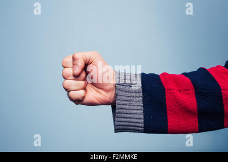 Young man clenching his fist Stock Photo