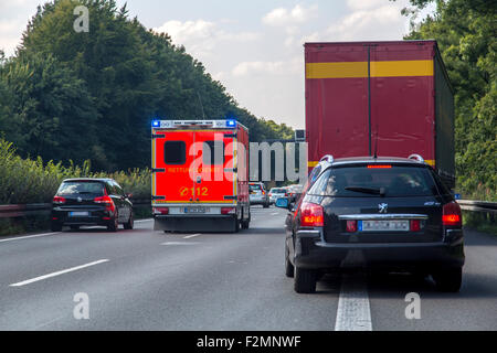 Accident on the Autobahn A 43, cars on the left and right side of the lane, to create an emergency lane for rescue services, Stock Photo