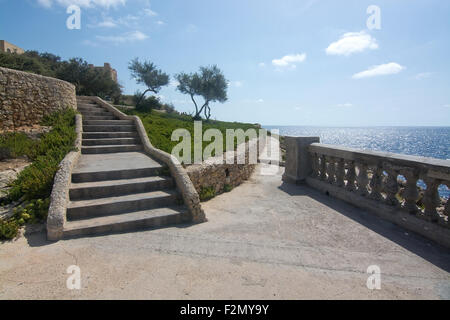 Park with trees and stairs coastal viewpoint near popular tourist attraction Blue Grotto on a sunny day in September Stock Photo