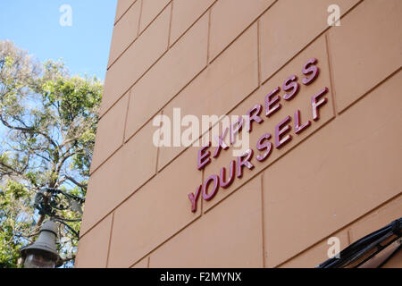 Express Yourself writen in ceramic letters on wall in Soho district of Malaga, Spain. Stock Photo