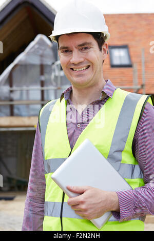Architect On Building Site Using Digital Tablet Stock Photo
