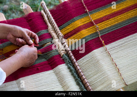 Peruvian  Quechua Woman from Cusco  Demonstrating Traditional Weaving Technique. Stock Photo