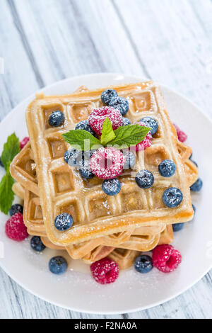 Waffles with mixed Berries and Honey (detailed close-up shot) on wooden background Stock Photo