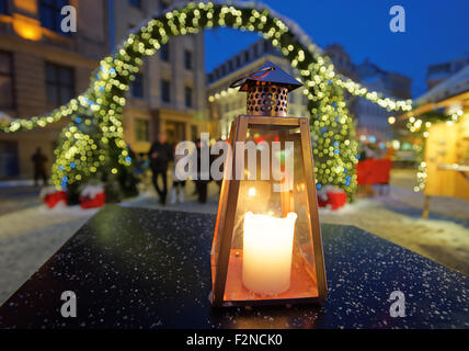 Lantern on a table on the background of the Christmas market in Riga Dome square (Latvia) Stock Photo