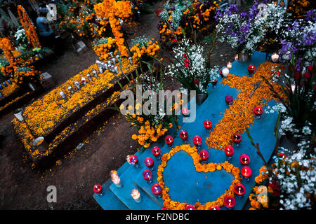 Decorated graves, covered by cempasúchil flowers, are seen during the Day of the Dead celebration in Tzintzuntzan, Mexico. Stock Photo
