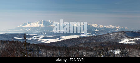 Panorama of Mountain Range in winter, High Tatras, Slovakia. View from Jaworzyna mountain, Krynica-Zdroj, Poland. Stock Photo