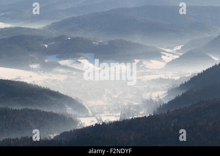 View of Valley in winter. Krynica-Zdroj from mountain top Jaworzyna. Stock Photo