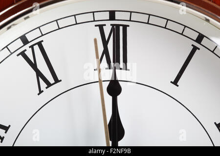 Twelve o'clock. Last second. Wooden table clock. Stock Photo