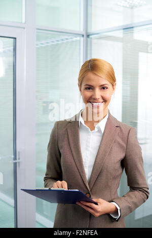 Happy businesswoman looking at camera in office Stock Photo