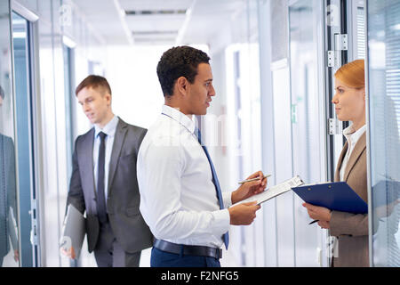 Young businessman consulting his colleague in office Stock Photo