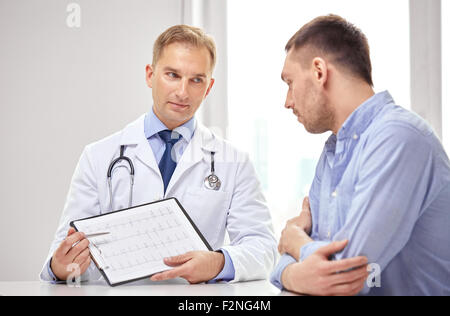 doctor and patient with cardiogram on clipboard Stock Photo