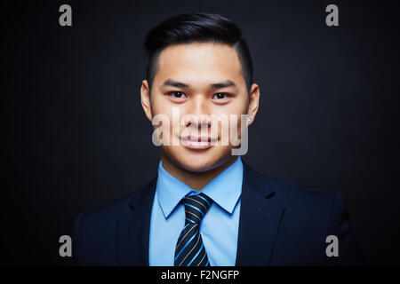 Face of handsome businessman looking at camera Stock Photo