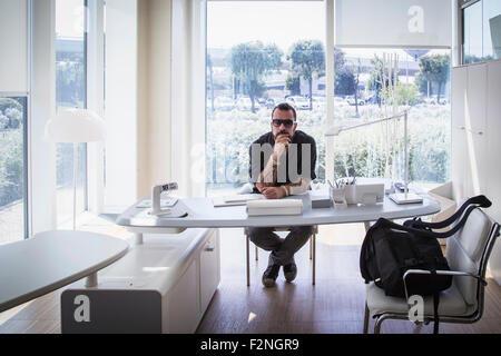 Caucasian businessman sitting in modern office Stock Photo