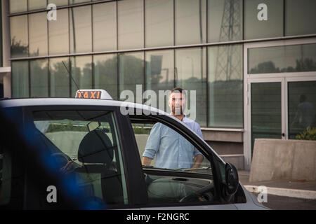 Caucasian man walking towards taxi Stock Photo