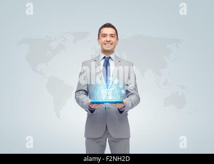 businessman with shopping cart over tablet pc Stock Photo