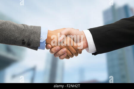 businessman and businesswoman shaking hands Stock Photo