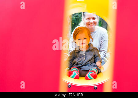 Caucasian mother and daughter playing at playground Stock Photo
