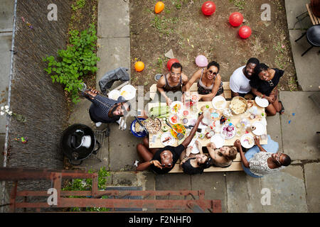 High angle view of friends enjoying backyard barbecue Stock Photo