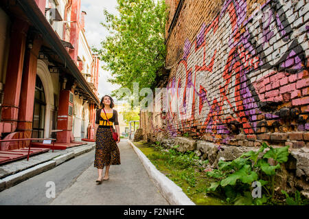 Caucasian woman walking in city street Stock Photo