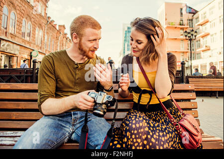 Caucasian couple checking photos on digital camera Stock Photo