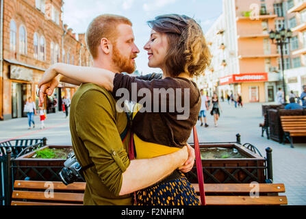Caucasian couple hugging in city Stock Photo