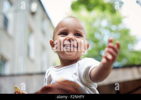 Mixed race baby boy smiling outdoors Stock Photo