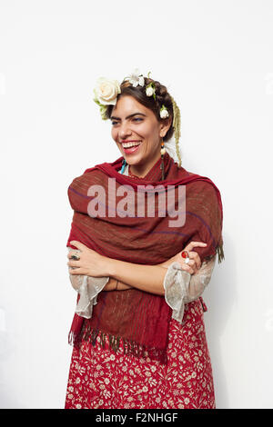 Stylish woman wearing shawl and flowers in hair Stock Photo