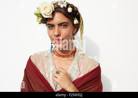 Stylish woman wearing shawl and flowers in hair Stock Photo