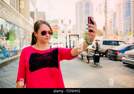 Caucasian teenage girl taking self portrait on cell phone Stock Photo