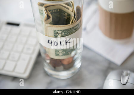 Close up of savings cup on office desk Stock Photo