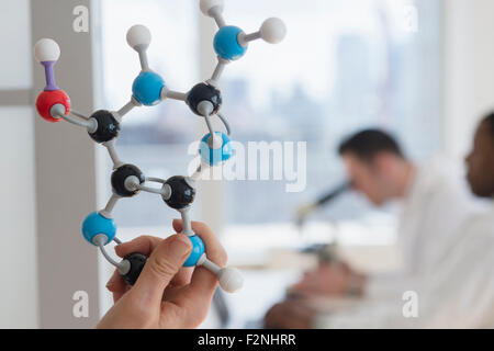 Close up of scientist holding molecular model in lab