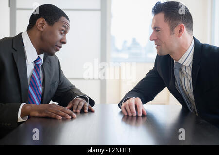 Businessmen talking in office meeting Stock Photo