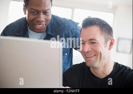 Men using computer in office Stock Photo