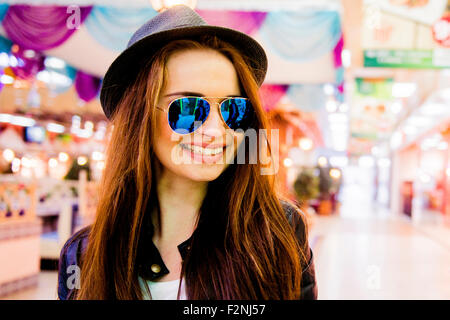 Caucasian woman smiling in shopping mall Stock Photo