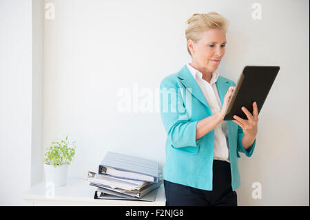 Caucasian businesswoman using digital tablet in office Stock Photo
