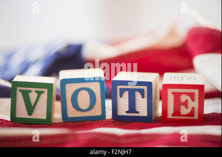 Close up of vote toy blocks on American flag Stock Photo