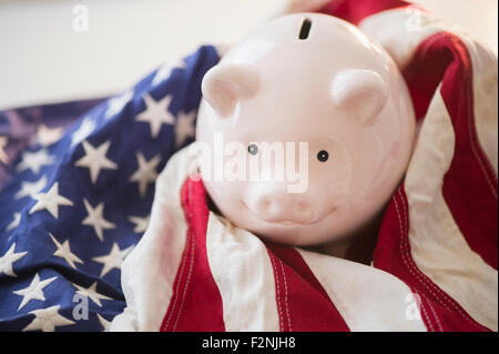 Close up of piggy bank and American flag Stock Photo