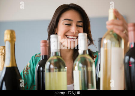 Woman choosing bottle of wine Stock Photo