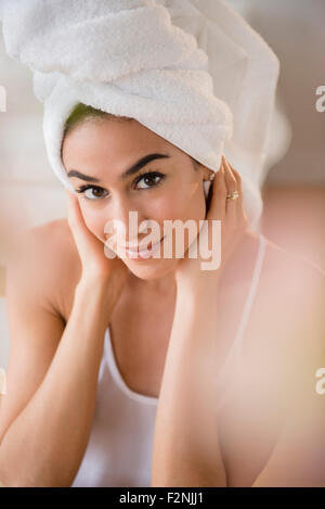 Woman drying her hair with towel Stock Photo