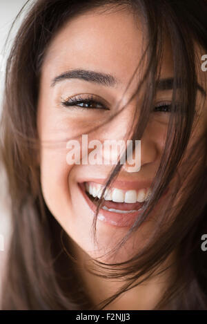Close up of laughing woman with messy hair Stock Photo